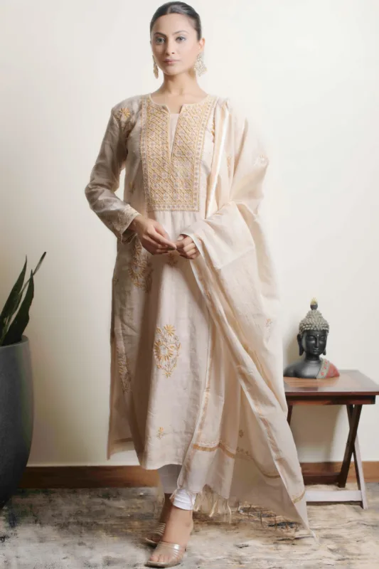 A sophisticated ensemble showcasing intricate Lucknowi Chikankari embroidery on fawn Tissue fabric.