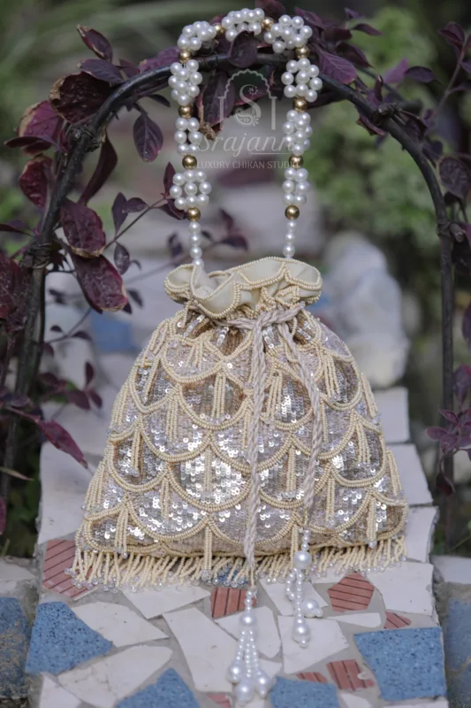 "Beige Pure Georgette Lucknowi Chikankari Potli Bag adorned with Pearl and Sequin Embellishments"