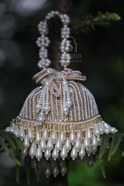 "Beige Pure Georgette Lucknowi Chikankari Potli Bag adorned with Pearl and Sequin Embellishments"