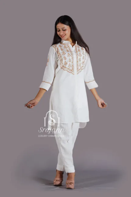 A coordinating set featuring intricate hand embroidery in the traditional Lucknowi Chikankari style, crafted from premium white linen fabric.