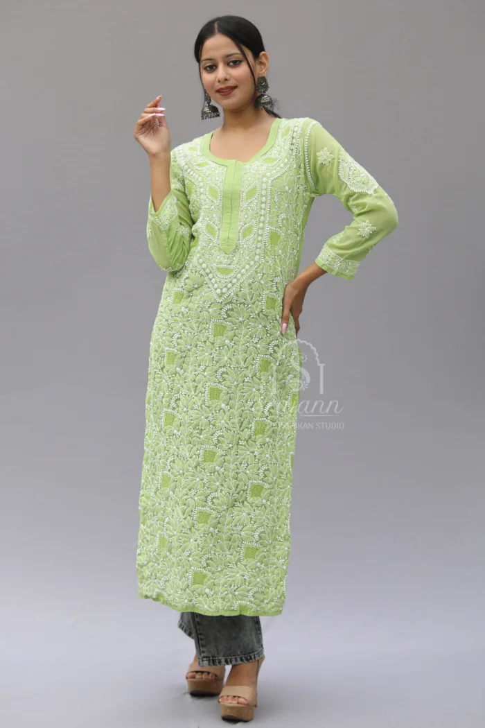 Hand-embroidered green cotton kurti featuring traditional Lucknowi Chikankari work. The kurti has a straight cut and intricate embroidery details, providing a sophisticated and elegant look. Suitable for a variety of occasions.
