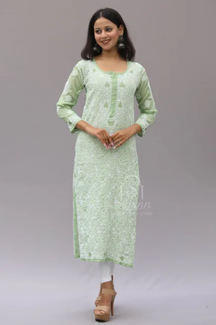 Hand-embroidered green cotton garment featuring intricate Lucknowi Chikankari work in a straight fit design. The piece displays delicate patterns on the fabric, showcasing traditional Indian craftsmanship and elegance