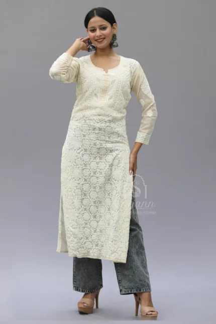 Image of a beige cotton kurti with intricate Lucknowi Chikankari hand embroidery by Srajann. The kurti features traditional floral motifs and delicate detailing, giving it an elegant and timeless appearance. It is set against a white background.